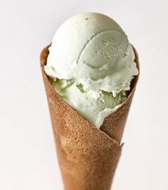 an ice cream cone filled with green and white toppings