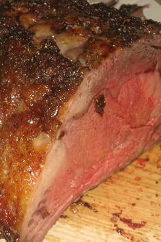 a piece of meat sitting on top of a wooden cutting board