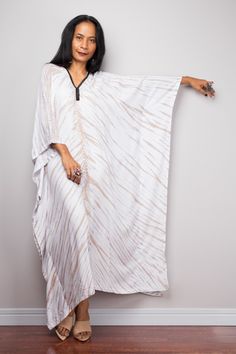 "Tie Dye kaftan dress | Cotton kaftan | Tie dye dress | resort beachwear caftan | Summer kaftan Produced by NUICHAN PRODUCT SIZE : One Size Fits Most These are the exact measurements from the dress, measured whilst laying flat >> * Chest : up to 50\" * Waist : 50\" * Hips : 50\" * Sleeve length from neckline to hem : 20\" * Length 49\" NOTE : * Model chest : 32\", waist : 24\" hips : 35\" * Combined Height is 5\"6 > I'm 5\"2 (158cm) and I'm wearing 4\" heels in the pictures MATERIAL * C Bohemian Summer Beach Abaya, Beach Tunic Abaya Free Size, Beach Abaya Free Size Maxi Length, Beach Abaya In Maxi Length, Summer Beach Abaya In Free Size, Bohemian V-neck Abaya For Beach, Maxi Length Abaya For Summer Vacation, Free Size Maxi Thobe For Beach, Free-size Maxi Thobe For Beach