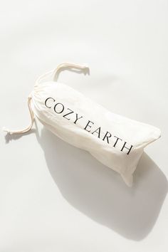 a white bag with the word cozy earth written on it