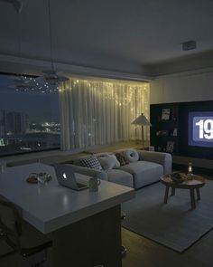 a living room filled with furniture and a flat screen tv sitting on top of a wall