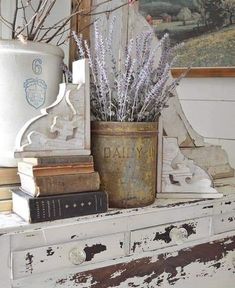 an old dresser is decorated with flowers and books