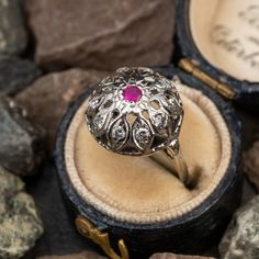 This lovely floral ring is crafted of 14k white gold and features a lab created ruby center with natural diamond accents. The ring is currently a size 4. Vintage Ruby Rings, Antique Engagement Rings Sapphire, Estate Jewelry Rings, Floral Ring, Ruby Engagement Ring, Antique Engagement Rings, European Cut Diamonds, Engagement Rings Sapphire, Diamond Wedding Rings