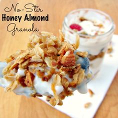 a spoon full of granola and yogurt on a plate with the words no - stir honey almond granola