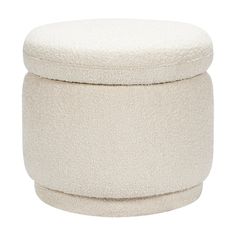 a white ottoman with a round cushion on top and an open lid in the shape of a footstool