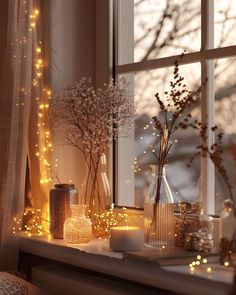 a window sill filled with vases and flowers next to a window covered in fairy lights