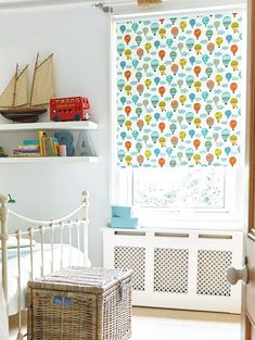 a child's room with a bed, window and toy boat on the wall