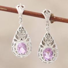 Glowing with lilac allure amethyst centers these beautiful earrings. Sterling vines entwine sensuously in traditional jali or cutout work. Hema works in silver for this very feminine design. .925 Sterling silver Purple Earrings With Intricate Design For Gift, Purple Earrings With Intricate Design As Gift, Ornate Purple Pierced Earrings, Formal Lavender Earrings, Elegant Purple Gemstone Chandelier Earrings, Lavender Gemstone Earrings, Purple Pierced Earrings For Wedding, Elegant Purple Pierced Earrings, Handmade Amethyst Chandelier Earrings