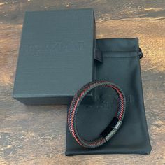 Handcrafted from premium leather Astro is an elegant bracelet, as tough as it looks. Red leather strips weave up and down the wide band, adding a dash of spark. With a minimalistic magnetized stainless steel clasp in black rhodium, it stacks effortlessly with other bracelets and watches, but is substantial enough to hold its own. Premium Nappa Leather Stainless Steel Clasp with Rhodium Bracelet, 10mm Wide Meaningful Jewelry, Elegant Bracelet, Black Agate, Tungsten Ring, Black Rhodium, Wide Bands, Jewelry Pouch, Nappa Leather, Precious Metals