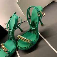 Looking for a summery and chic pair of heels? These green sandals are perfect! They feature an ankle strap and gold chain detailing that add a touch of glamour. Whether you're headed to the beach or a summer wedding. these heels will have you looking your best. Upper: Leather Lining: Leather Outsole: TPR Toe: Open Toe Closure: Buckle Strap Color: Black. Green. Purple is_handmade: Yes The above measurement is based on size 6. with one size larger. 0.5cm wider. Summer Sandals With Ankle Strap And Chain Detail, Summer Ankle Strap Sandals With Chain Strap, Summer Evening Sandals With Chain Detail, Trendy Chain Strap Sandals For Party, Trendy Chain Strap Party Sandals, Summer High Heel Sandals With Chain, High Heel Sandals With Chain For Summer, High Heel Chain Sandals For Summer, Green Ankle Strap Sandals For Party