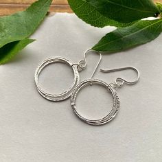 Elegant, Light & Sparkly Double Hoop Earrings -- Beautiful with all of the milestone necklaces. These are perfect for everyday wear.✦ All metal is bright sterling silver.✦ Circles have been given a unique hammered texture, and are organically shaped.✦ Each jump ring has been soldered closed for extra handmade quality.✦ Earrings are 1 5/8 inches long, including the french hook ear wires✦ Largest circles are 7/8" wide. Double Hoop Earrings, Jump Rings, Ear Wires, Circles, Everyday Wear, Hoop Earrings, Necklaces, Texture, Sterling Silver