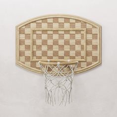 a basketball hoop mounted to the side of a wall with a checkerboard pattern on it