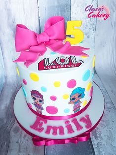 a birthday cake with the number five on it and a pink bow around the top