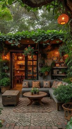 an outdoor living area with couches, tables and potted plants