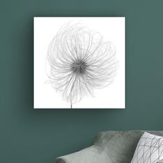 a black and white photo of a dandelion on a green wall