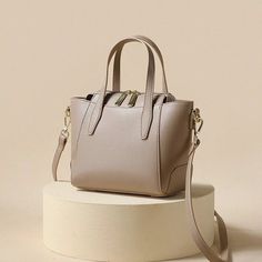 Indulge in sophistication with our Light-Toned Leather Tote Bag. Crafted for the modern woman, this elegant handbag adds a touch of refined style to any occasion. The light colors elevate the chic and timeless appeal, making it the perfect accessory for your graceful ensemble. Lining Material: Polyester Main Material: Split Leather Interior Slot Pocket Handbag Size (inches): 7.87x6.7x4.3 inches Handbag Size (cm): 20x17x11 cm Chic Cream Satchel Box Bag, Modern Beige Evening Bag For Everyday Use, Classic Beige Crossbody Evening Bag, Beige Satchel For Evening, Beige Box Bag With Detachable Handle, Classic Beige Shoulder Bag With Zipper Closure, Chic Cream Box Bag With Double Handle, Elegant Beige Crossbody Box Bag, Elegant Cream Satchel Evening Bag