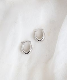 Elevate your style with our minimal Point Huggie Hoops. With a subtle tear-drop silhouette, these huggies are unique enough to feel like an understated statement and versatile for everyday wear. Trust us; you won't want to take them off. Minimal Silver Jewelry, Earring Aesthetic, Earring Stacks, Minimalist Earrings Silver, Minimalist Jewelry Silver, Xmas Wishlist, Earrings Minimal, Earrings Aesthetic, Silver Jewels