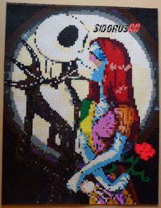 a cross stitch picture of a woman and cat