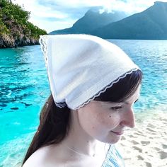 a woman wearing a white hat on the beach