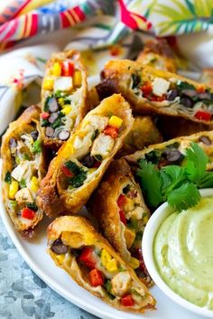 a white plate topped with tacos and guacamole