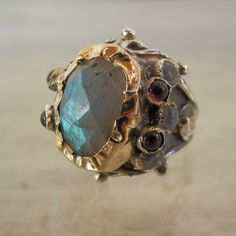 Labradorite Engagement Ring, 9K and Silver Labradorite Queen Ring, Gift for Her, Unique Engagement Ring, Women's Gift, Vintage Style RingThis antique style statement ring is a unique and OOAK piece for brides to be!A unique labradorite ring will make you feel like a real queen on your special day! At the center, you will find an enchanting labradorite gemstone on 9K solid gold bezel, welded on sterling silver.The solid gold is also hammered around the labradorite and makes this ring a true and d Unique Gold Sapphire Ring With Gemstone Accents, Unique Yellow Gold Ruby Ring, Unique Gold Emerald Ring With Gemstone Accents, Unique Moonstone Ring With Gemstone Accents For Anniversary, Unique One-of-a-kind Sapphire Ring For Anniversary, Labradorite Engagement Ring, Queen Rings, Vintage Style Rings, Unique Engagement Ring