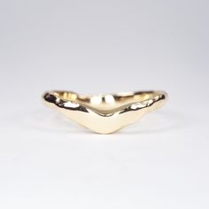 a gold ring with wavy shapes on it