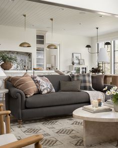 a living room filled with furniture and lots of pillows on top of the couches