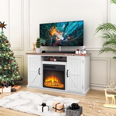 a flat screen tv sitting on top of a white entertainment center next to a christmas tree