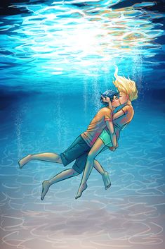 a man and woman are kissing under the water