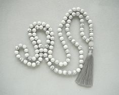 Howlite Mala Necklaces Hand Knotted Grey Tassel Necklace for Man Women Gift White Necklace Yoga Meditation Necklace 108 Mala Bead Necklace - 8mm Natural White Howlite Beads - 12mm Jade Guru bead - 9cm Grey tassel Visit my shop here: https://www.etsy.com/ru/shop/BonBonStones Please contact me with any questions. I'm happy to help! White Beaded Necklaces With Tassels As Gift, White Beaded Necklaces With Tassels For Gift, White Beaded Tassel Necklaces As Gift, White Long Tassel Necklace As Gift, Adjustable White Tassel Necklace Gift, Handmade White Tassel Necklace As Gift, Handmade White Tassel Necklace For Gift, Mint Bracelet, Green Stone Pendant