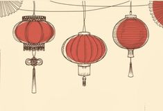 three red lanterns hanging from a wire with fan shaped lights on it's sides