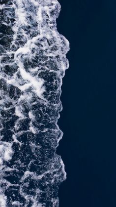 an airplane is flying over the ocean waves