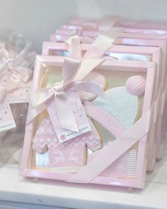 some pink and white boxes with bows on them