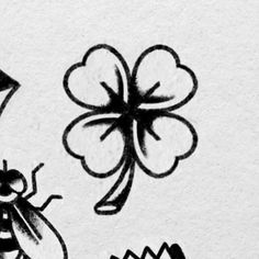 a black and white drawing of a bug next to a four leaf clover with a ladybug on it