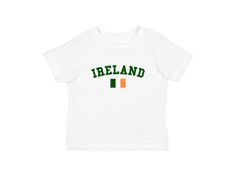 Ireland Baby Tee White t shirt with with green Ireland spellout graphic and Irish flag. Blokette and soccer inspired shirt. Measurements (in inches): Small- Width: 16 Length: 19.5 Medium- Width: 18 Length: 23 Large- Width: 19 Length: 25 Care Instructions: * Do not dry clean * Wash and dry inside out * Hang dry (preferred) or machine dry on a delicate setting * Use cold water * Use mild detergent * Do not bleach Green Short Sleeve Tops With Name Print, Green Short Sleeve Top With Name Print, 2000s Tops, Bebe T Shirt, Irish Baby, Irish Flag, St Patrick Day Shirts, Baby Tshirts, White Tshirt