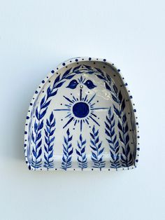 a decorative blue and white dish on a wall