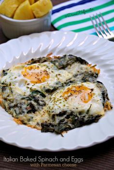 an egg and spinach casserole with parmesan cheese on a white plate