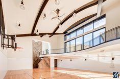 an indoor basketball court with wooden floors and white walls