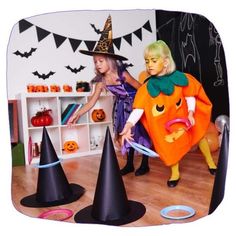 two children dressed up as witches and pumpkins