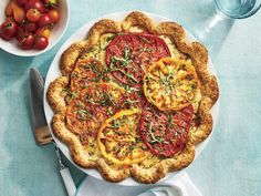 a pie with tomatoes and herbs on it