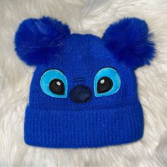 a blue beanie hat with big eyes