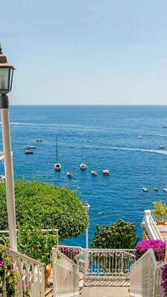 an outdoor patio area overlooking the ocean and boats