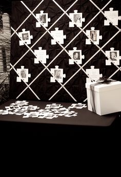 a white box sitting on top of a table next to a black and white wall