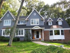 a gray house with white trim and windows