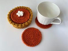 two crocheted coasters and a coffee cup