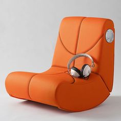 an orange chair with headphones attached to the back and armrests on it