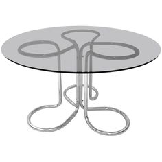 a glass table with metal legs and two circles on the top, against a white background