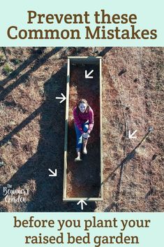 a person laying on the ground next to a garden bed