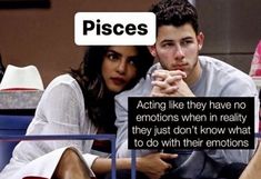 a man and woman sitting next to each other in front of a sign that says pisces