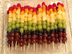 fruit skewers are arranged in the shape of rainbows